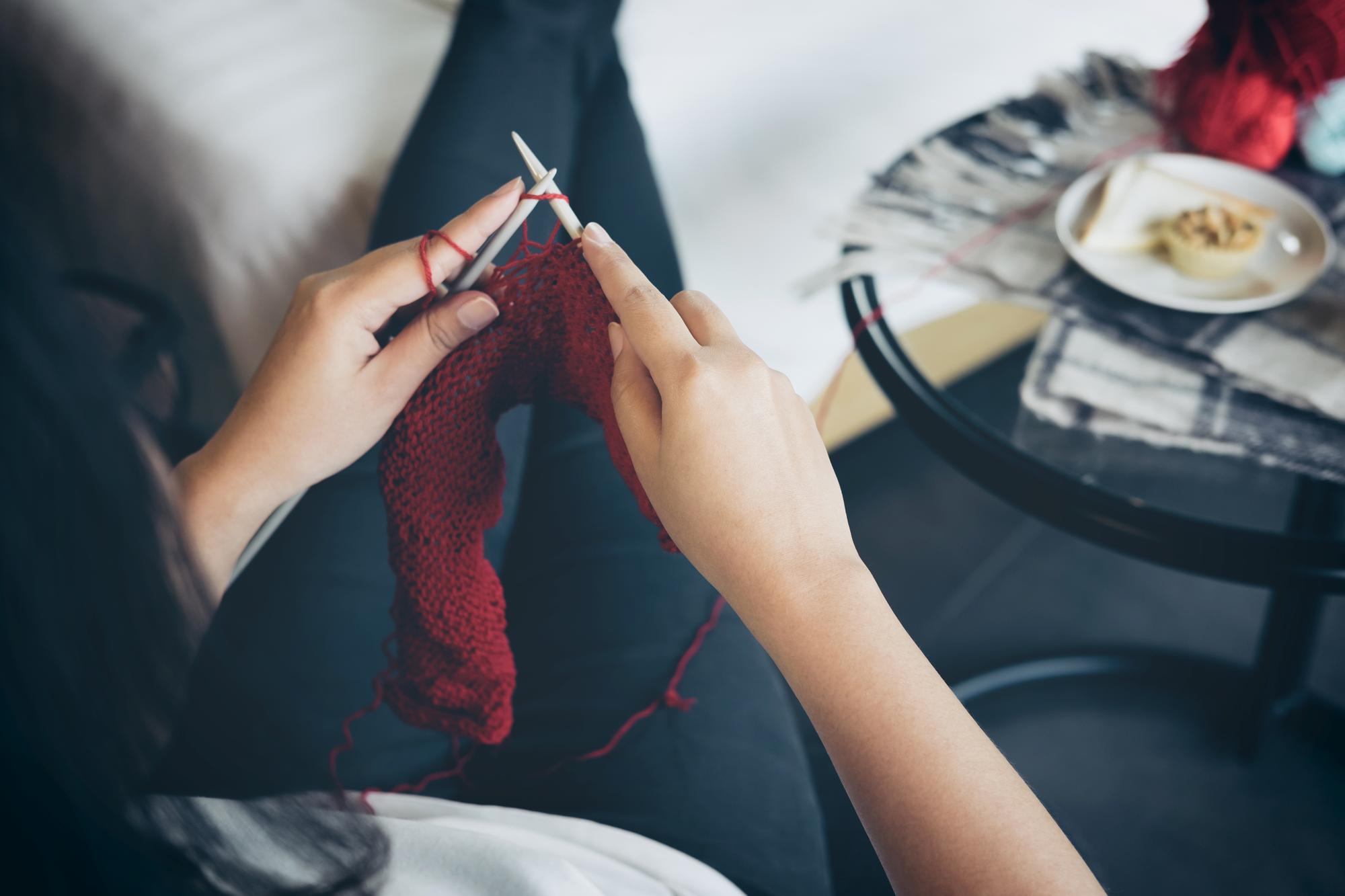 Artisan at work stitching an embroidered sleeve