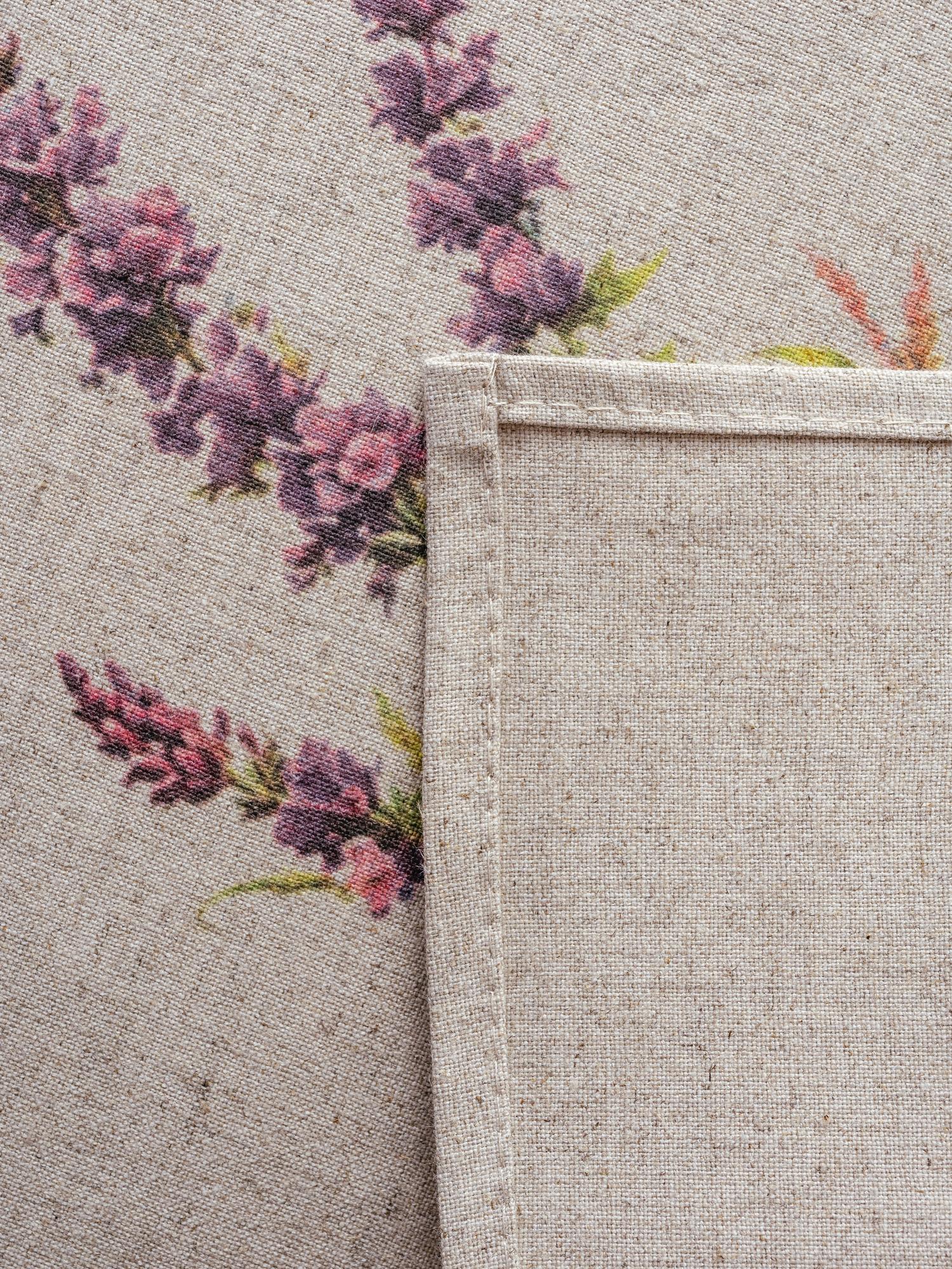 Close-up of delicate floral embroidery on linen